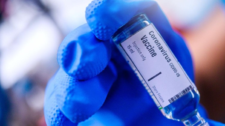 COVID-19 vaccine and syringe sitting over blue financial graph background. Selective focus. Horizontal composition with copy space. COVID-19 Vaccine and Stock market and finance concept.