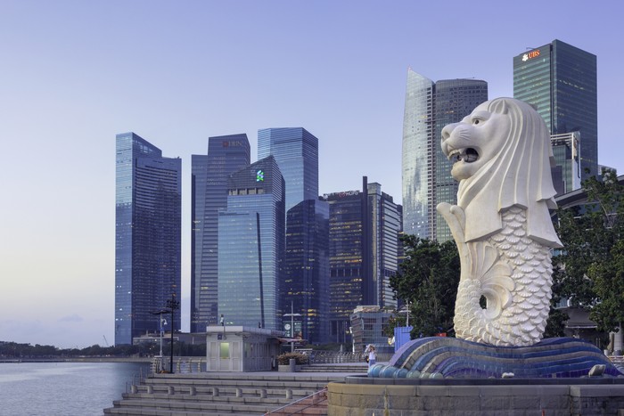 View of the merlion statue of Merlion Park, and the financial district in downtown Singapore. The merlion is a symbol and mascot of Singapore.