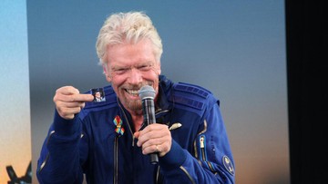 Richard Branson holds up a photograph of CBS 