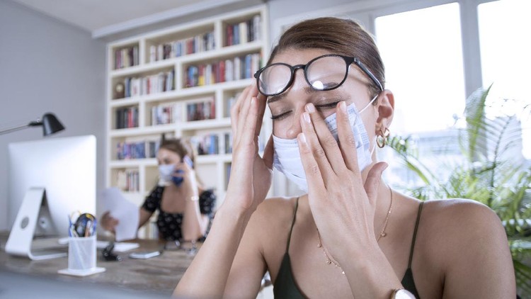 two woman working with protective face mask at office