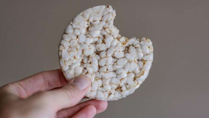 Human hand holding rice cracker