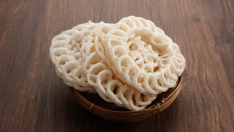 Krupuk or Kerupuk, Indonesia traditional crackers, served in bamboo plate on wooden table.