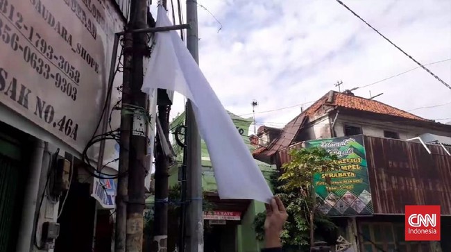 Pengibaran bendera merah putih menyimbolkan kondisi menyerah karena masalah ekonomi imbas dari kebijakan PPKM tanpa bantuan keuangan dari pemerintah.