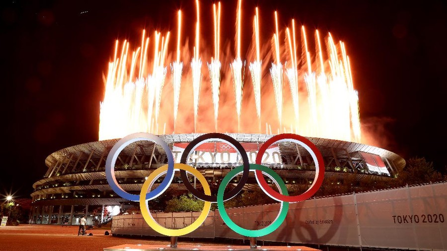 TOKYO, JAPAN - JULY 23: The Olympic Rings are seen outside the stadium as fireworks go off during the Opening Ceremony of the Tokyo 2020 Olympic Games at Olympic Stadium on July 23, 2021 in Tokyo, Japan. (Photo by Lintao Zhang/Getty Images)