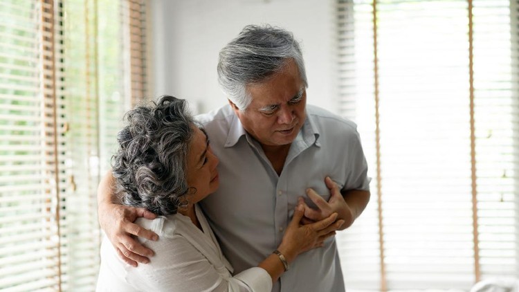 Senior Woman Suffering From Chest Pain While Sitting on Sofa at Home. Old Age, Health Problem, Vision and People Concept. Heart Attack Concept. Elderly Woman Suffering From Chest Pain Indoor