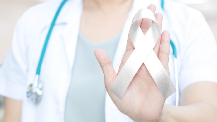 Female doctor in white uniform with white pearl ribbon awareness in hand for Dating Violence,Emphysema,Lung Cancer awareness ,Lung Disease,Mesothelioma,Multiple Sclerosis,Retinoblastoma Cancer (eye)