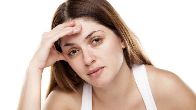 tired young woman on white background