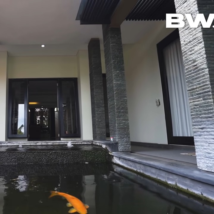 <p>Rumah pria yang akrab disapa Ajik Krisna itu didominasi dengan nuansa monokrom dari bebatuan alam. Ajik Krisna juga memelihara ikan koi berukuran besar di kolam rumahnya. (Foto: YouTube Boy William)</p>