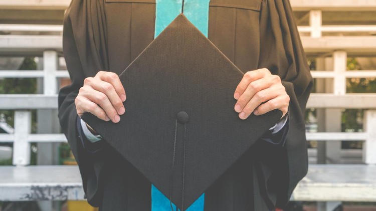 Proud mother hugging her graduating son and looking very happy â education concepts