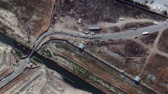 In this satellite photo released by Maxar Technologies, a crowd at a checkpoint outside of Kabul's international airport is seen amid evacuations on Monday, Aug. 23, 2021. A firefight outside Kabul's international airport killed an Afghan soldier early Monday, highlighting the perils of evacuation efforts as the Taliban warned that any attempt by U.S. troops to delay their withdrawal to give people more time to flee would 