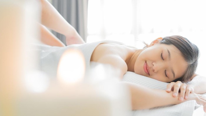 Young Asian woman  in spa salon getting massage.
