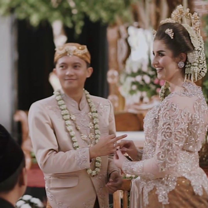 <p>Tess dan Tom akhirnya resmi menjadi pasangan suami istri. Mereka tampak bahagia ketika saling memasangkan cincin nikah. (Foto: YouTube Tess & Tom)</p>