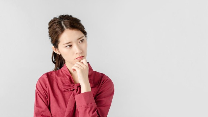 Thinking asian woman.