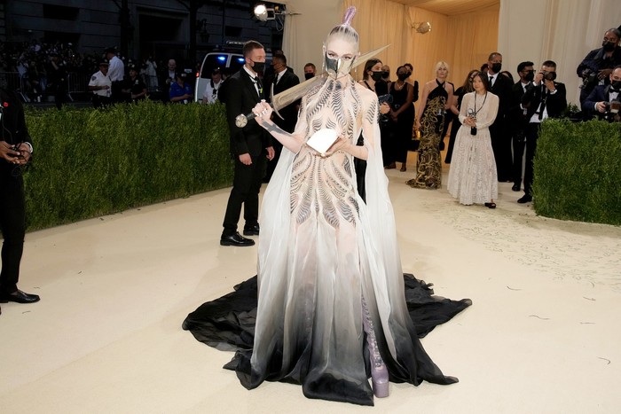Grimes membawa nuansa teatrikal ke red carpet Met Gala 2021. Ia memakai gaun Iris Van Herpen sembari membawa 'pedang' sebagai aksesori.Foto: Getty Images