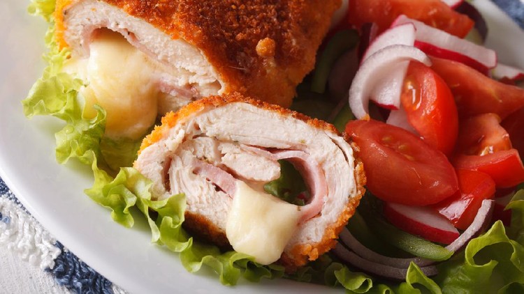 cordon bleu Chicken cordon bleu and fresh vegetable salad on the plate closeup. horizontal