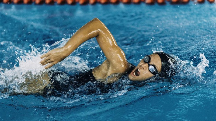 Female freestyle swimming competitor in action