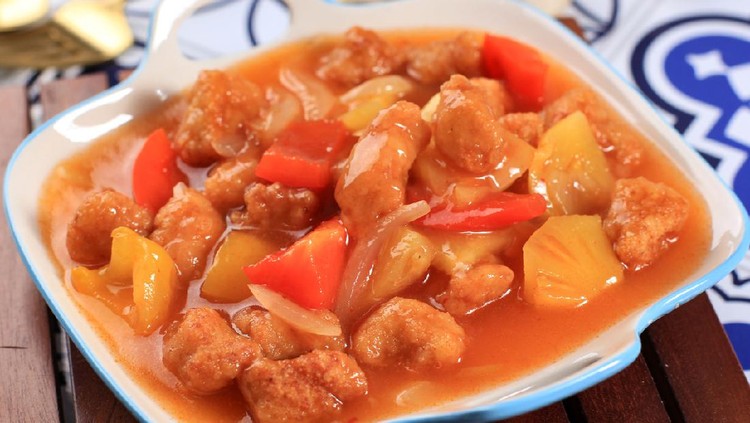 Ayam kuluyuk Ayam Kuluyuk or Ayam Goreng Saus Asam Manis, Fried Chicken with Sweet Sour Sauce, Chinese Indonesian Culinary Food Served on White Rim Blue Plate.