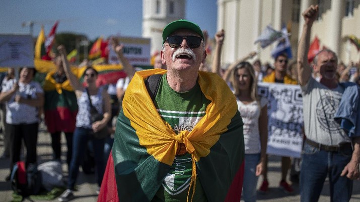 Lithuania Anti-vaccination protesters take part in a protest at Cathedral Square in Vilnius, Lithuania, Friday, Sept. 10, 2021, against the government's restrictions for people who have not developed immunity to COVID-19. (AP Photo/Mindaugas Kulbis)