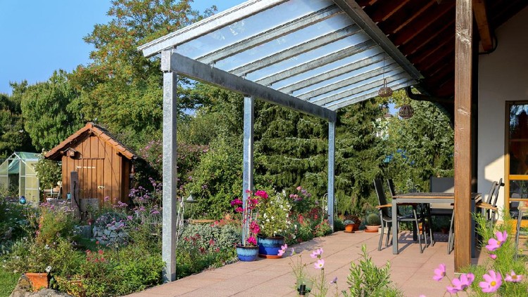 Glass patio cover with a view of the garden.