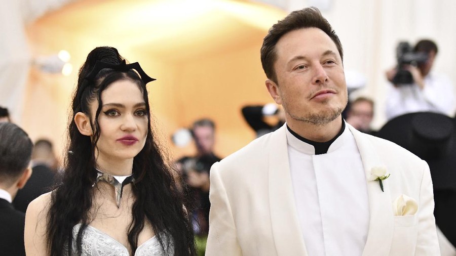 FILE - Grimes, left, and Elon Musk attend The Metropolitan Museum of Art's Costume Institute benefit gala in New York on May 7, 2018. The Tesla and SpaceX founder tells the New York Post that he and the Canadian singer are “semi-separated.” But he says they remain on good terms, she still lives at his house in California and they continue to raise their 1-year-old son together. (Photo by Charles Sykes/Invision/AP, File)