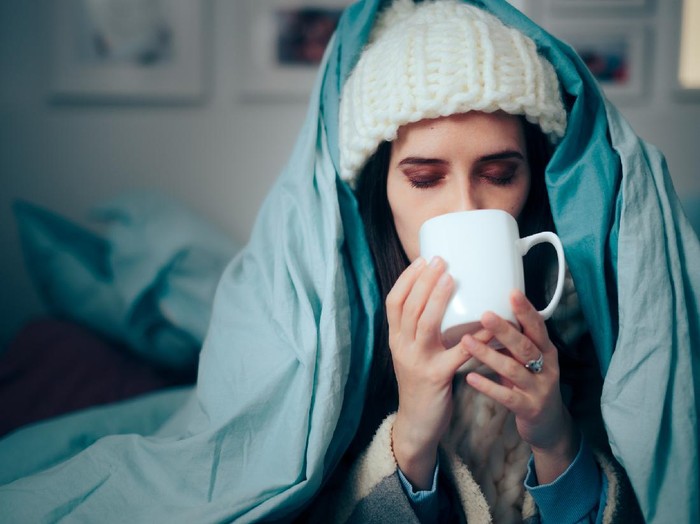 Sick person with flu symptoms using natural medicine treatment infusion tea