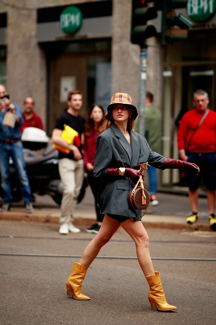 A formal blazer can look edgy thanks to a cape-like cut and when worn with ankle boots and a bucket hat. Photo: livingly.com/IMAXtree