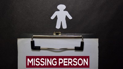 Missing Person write on a book isolated on black table.