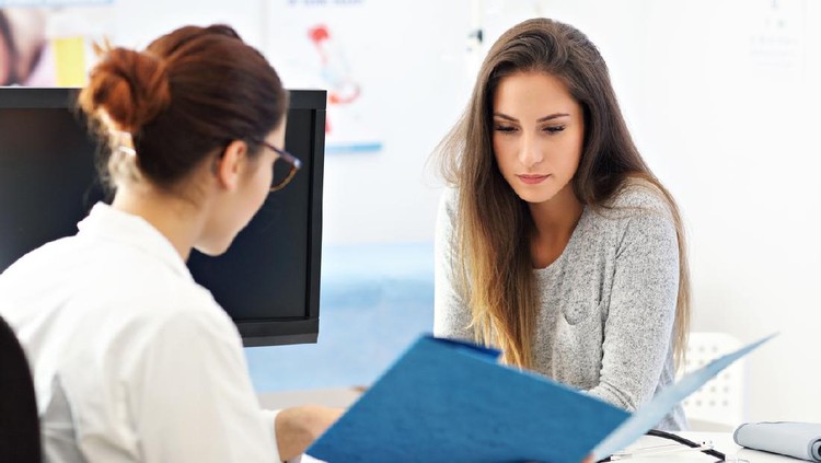 Picture of adult woman having a visit at female doctor's office