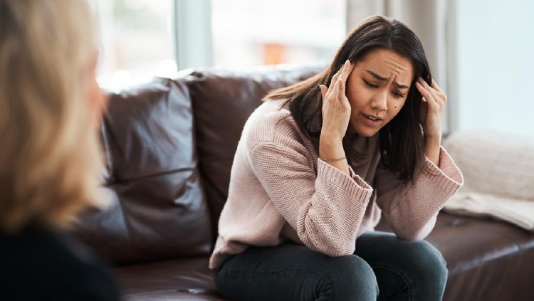 Shot of a young woman having a therapeutic session with a psychologist