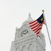 Malaysia's national flag is hoisted next to an 18-metre high and 28-metre-wide snow statue of the Sultan Abdul Samad building at situated at Malaysia square, during the 65th annual Sapporo Snow Festival on February 5, 2014. The week-long festival sta
