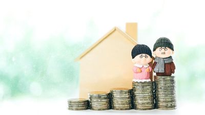 Retirement planning Concept of miniature old couple people figure standing on coin stack