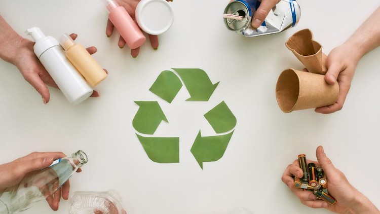 Top view of many hands holding different waste, garbage types with recycling sign made of paper in the center over white background. Sorting, recycling waste concept. Horizontal shot. Top view