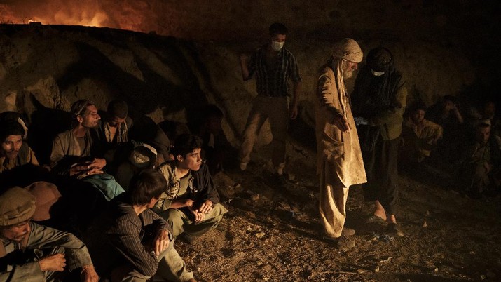 Drug users detained during a Taliban raid wait to be checked at a police station before being transferred to the Avicenna Medical Hospital for Drug Treatment in Kabul, Afghanistan, Friday, Oct. 1, 2021. At least 150 men were taken to the district police station, where all their belongings -- drugs, wallets, knifes, rings, lighters, a juice box -- were burned in a pile since they are forbidden to take them to the treatment center. (AP Photo/Felipe Dana)