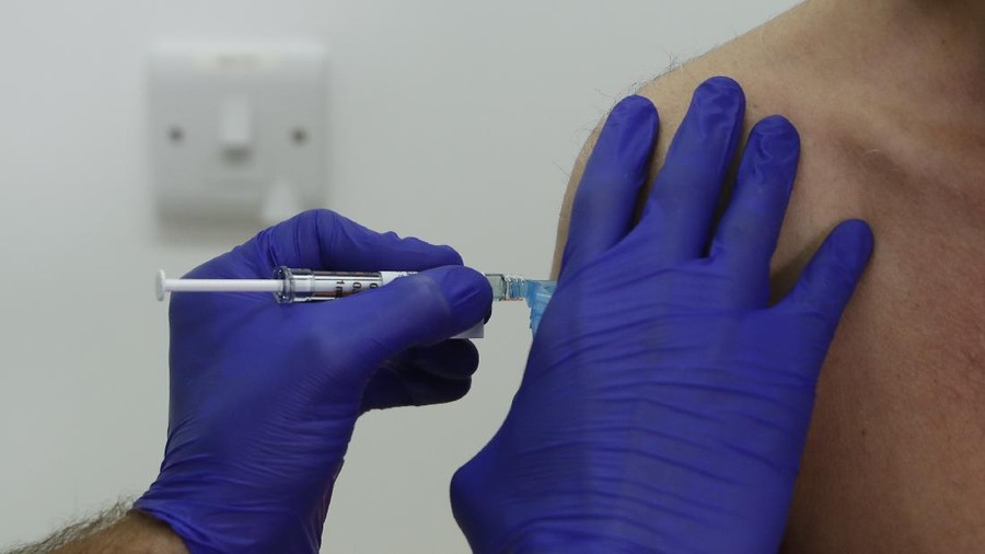 Phase 3 Novavax coronavirus vaccine trial vaccine volunteer Franklyn Howe is given an injection at St George's University hospital at in London, Wednesday, Oct. 7, 2020. Novavax Inc. said Thursday Jan. 28, 2021 that its COVID-19 vaccine appears 89% effective based on early findings from a British study and that it also seems to work — though not as well — against new mutated strains of the virus circulating in that country and South Africa. (AP Photo/Alastair Grant)