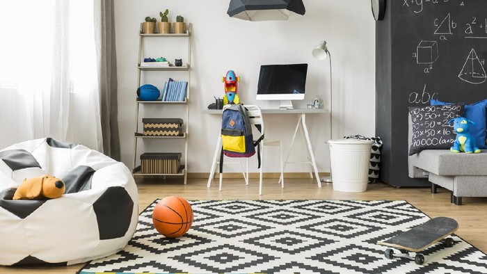 Spacious schoolboy room with window, soccer sack chair, pattern carpet, chalkboard, sofa, chair, desk, computer and wall regale