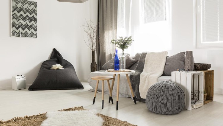 Light livng room with bean bag, comfortable sofa, DIY table, window and stylish decorative details