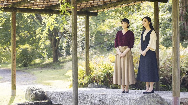In this photo provided Saturday, Oct, 23, 2021, by the Imperial Household Agency of Japan, Japan's Princess Mako, left, the eldest daughter of Crown Prince Akishino and Crown Princess Kiko, strolls with her younger sister Princess Kako, at the garden of their Akasaka imperial property residence in Tokyo, Japan on Oct. 6, 2021, ahead of her 30th birthday on Oct. 23, 2021 and her marriage on Oct. 26, 2021.(The Imperial Household Agency of Japan via AP)