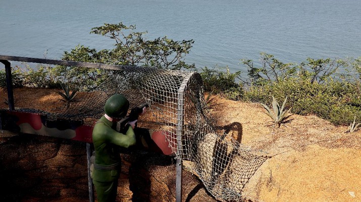A mannequin of a soldier aims in the direction of China at the coastal line of Lieyu Township, Kinmen, Taiwan, October 19, 2021. Sitting on the front line between Taiwan and China, Kinmen is the last place where the two engaged in major fighting, in 1958 at the height of the Cold War, and where memories of war are burned into minds decades later.  REUTERS/Ann Wang    SEARCH 