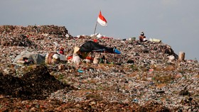 Indonesian national flag is seen at the Bantar Gebang landfill in Bekasi, West Java province, Indonesia, August 12, 2021. Picture taken August 12, 2021. To match Special Report ENVIRONMENT-PLASTIC/CEMENT   REUTERS/Willy Kurniawan