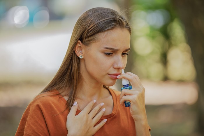 Sick Woman Holding Nasal Spray