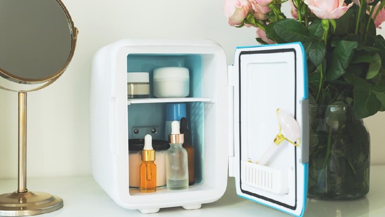 Mini fridge on the vanity table. Selfcare concept. Keep skincare, makeup and beauty product cool and fresh. Extend shelf live of creams, serums. Keep your beauty products organized and cool.