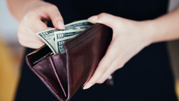 Woman is taking out money from wallet