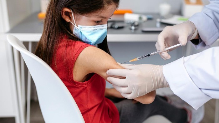 Little girl receiving coronavirus vaccine at doctor's office