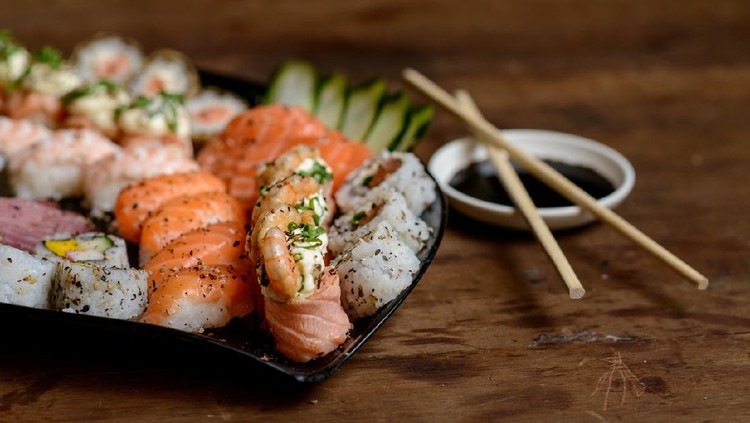 Japanese sushi sashimi boat seafood ship on the table, ready for delivery.