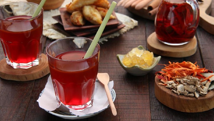 Wedang Secang or also known as Wedang Uwuh, is a traditional herbal drink from Imogiri district in Yogyakarta, Central Java. It is an infusion tea of local dried spices and herbs such as secang wood, ginger, nutmeg, cloves, clove leaves, cinnamon, cardamom, lemongrass and sweetened with rock sugar. The red color is obtained thru the secang wood. The tea is served in clear glass with a lemongrass dipped in. The spices and herbs used in making this herbal tea are arranged on the table.