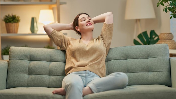 Portrait of beautiful woman resting on sofa at home