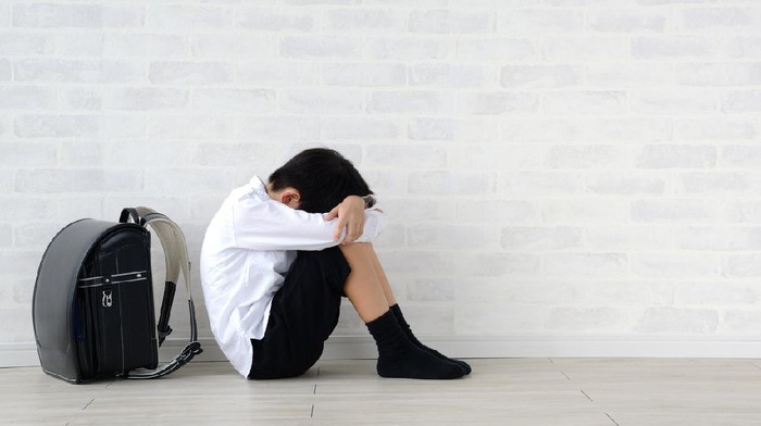 Child sitting alone in living room