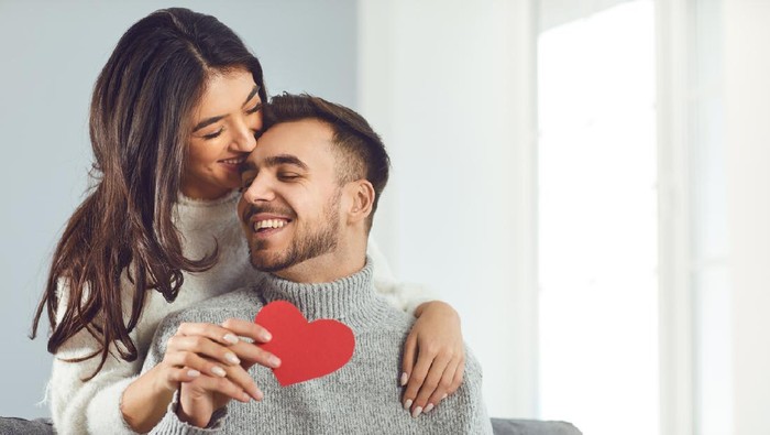 Valentine's day. Couple gives heart to the Valentine's Day in the room.