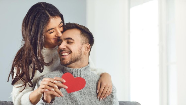 Valentine's day. Couple gives heart to the Valentine's Day in the room.