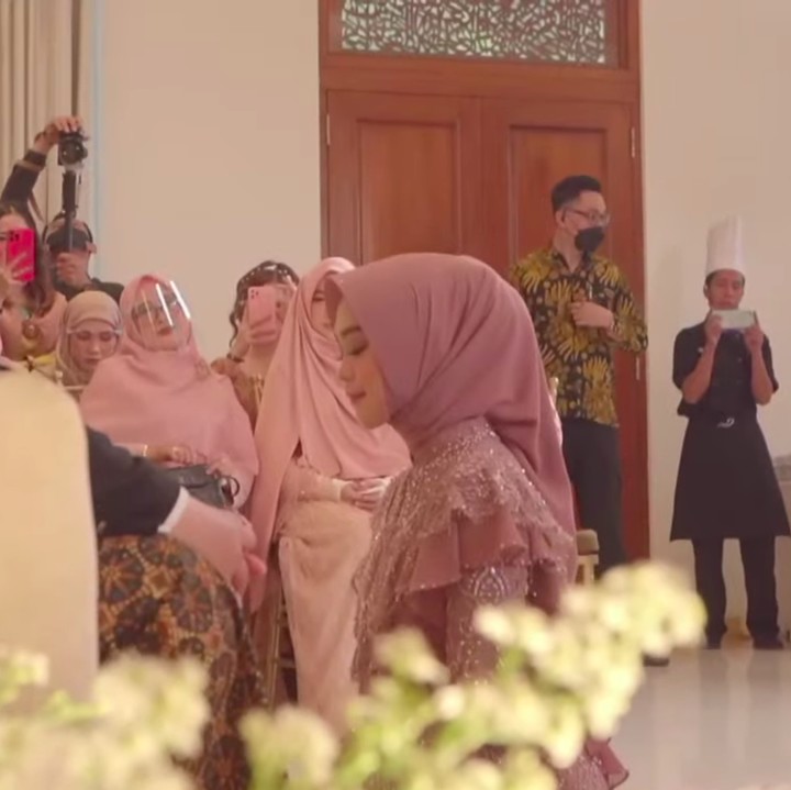 <p>Ria Ricis tampil menawan dengan balutan kebaya modern warna dusty pink. Ia juga mengenakan rok kain berwarna cokelat. (Foto: YouTube MOP Channel)</p>